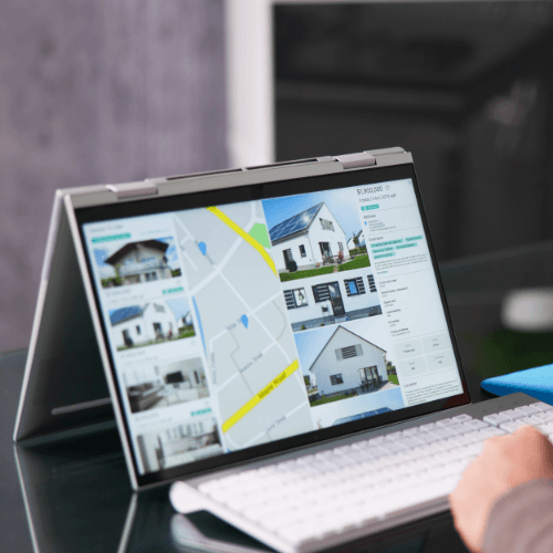 Laptop screen showing real estate listings and map for land development research services by Subdivision Summaries